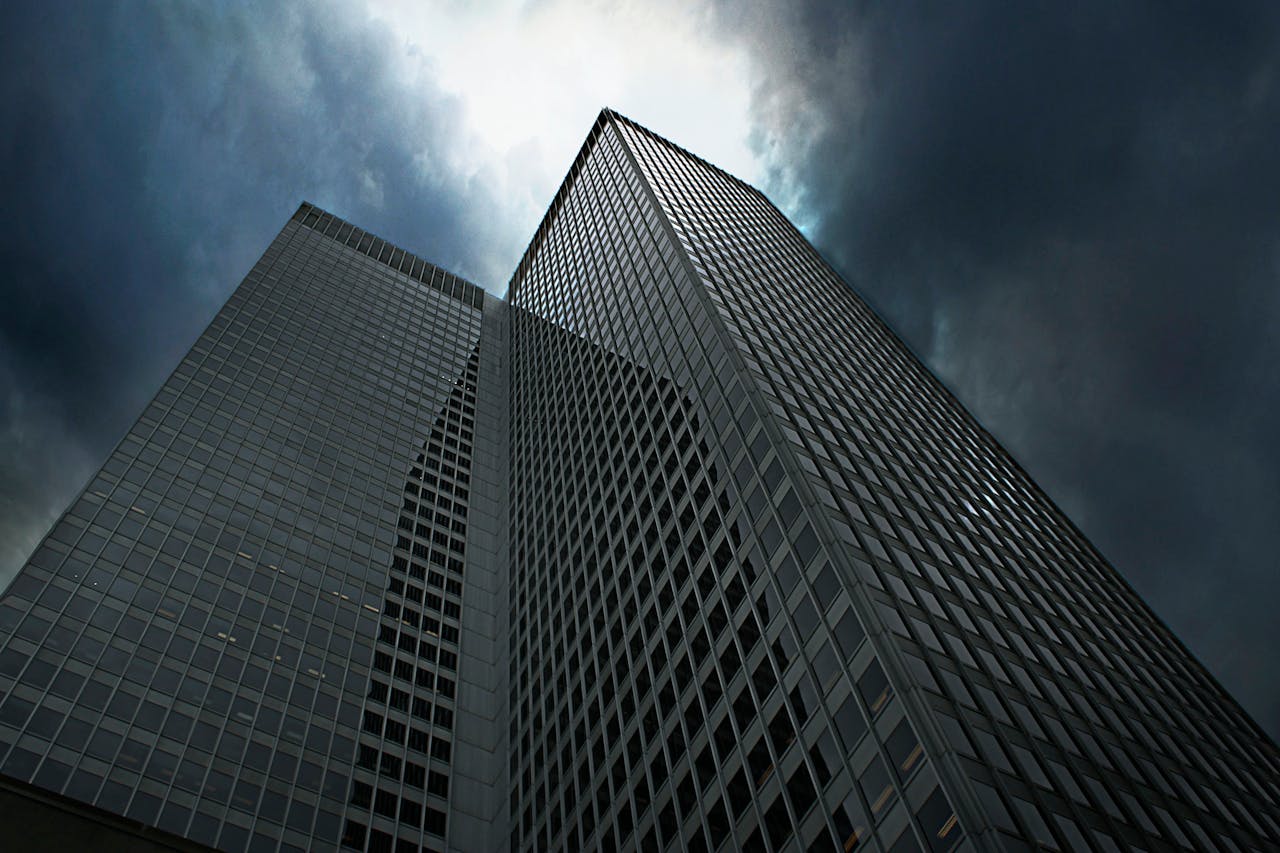 Dramatic view of towering skyscrapers in Montreal with ominous clouds overhead.